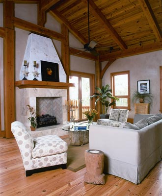 Exposed timbers, ceilings of heart pine, clay-covered walls and reclaimed-wood heart-pine flooring add beauty to the gathering room while revealing the home's solid construction.